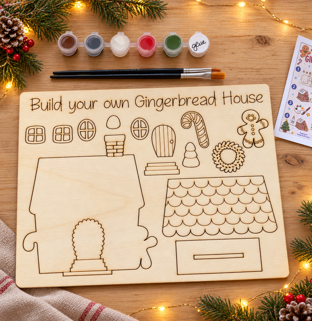 Unpainted wooden gingerbread house DIY kit with paints, brushes, glue and instructions