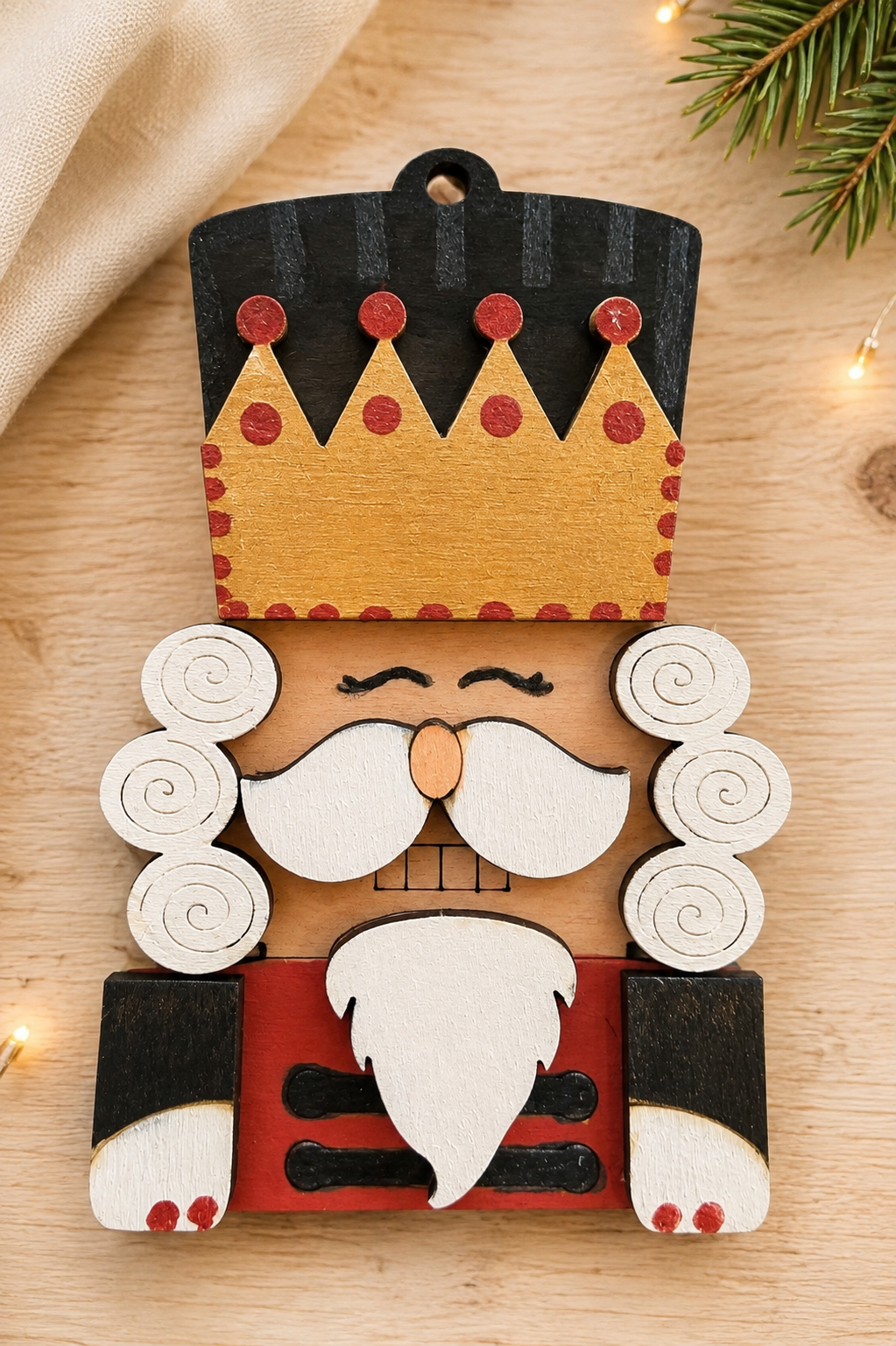 Painted wooden nutcracker ornament with crown – finished example