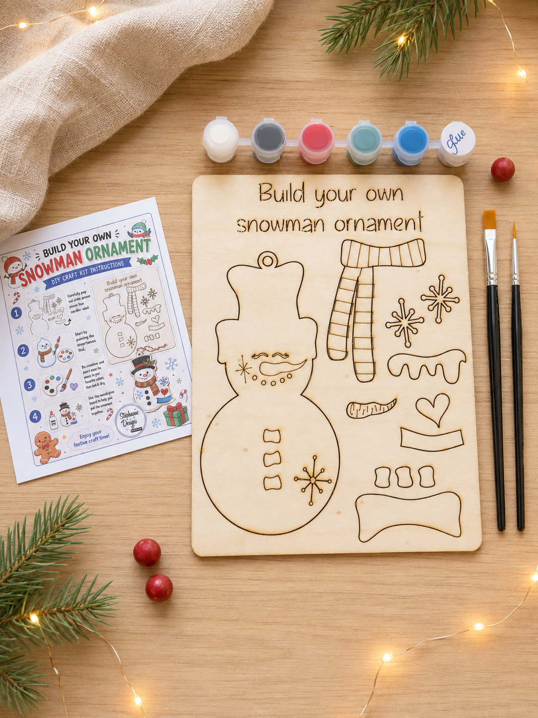 Unpainted wooden snowman DIY craft kit with paints, two brushes, glue and instructions